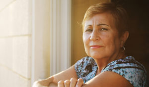 Portrait of senior woman looking from the balcony