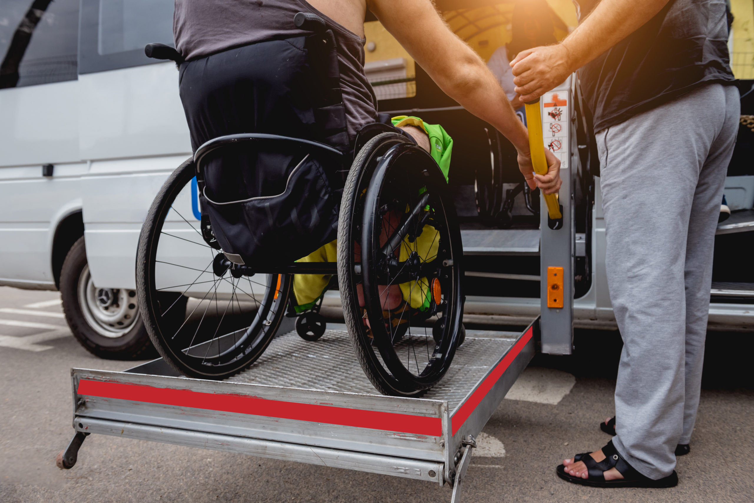 Disabled Man On Wheelchair Using Accessible Vehicle With Lift Mechanism.